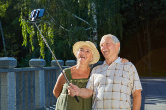 Senior couple taking selfie outdoors