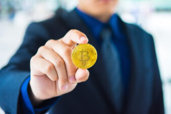 business man holding gold coin