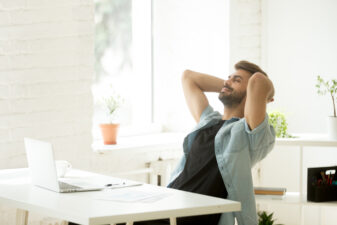 smiling relaxed man at his desk