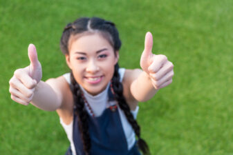 smiling woman doing a thumbs up