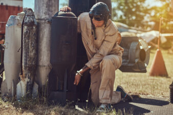 Portrait of a mechanic in uniform and flying helmet near to combat bombs for a bomber aircraft in an open-air museum