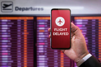 Man seeing flight delayed on phone