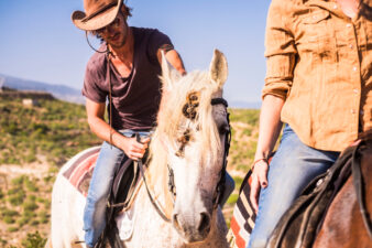 man wearing a cowboy hat on a horse