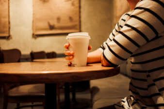 Woman sitting alone with a coffee