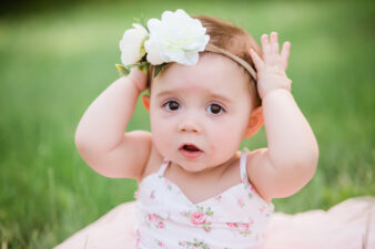 Cute baby girl with flower in hair