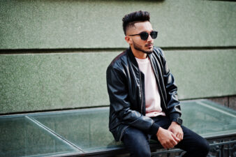 Stylish man wearing leather jacket and sunglasses