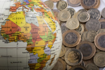 Turkish Lira coins by the side of a model globe