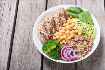 Buddha bowl with broccoli , quinoa , grilled chicken , avocado