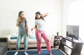 Two girls dancing in their living room