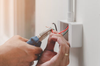 Person cutting wires with pliers