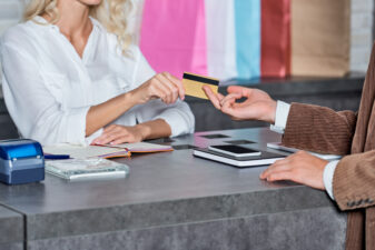 woman and man exchanging a credit card