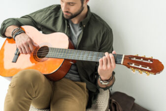 man playing an acoustic guitar