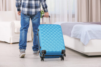 Man walking into hotel with luggage