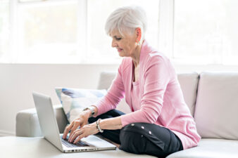 Senior woman using her laptop at home