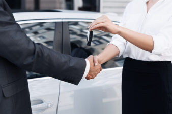 Handshake and handing over keys by consultant to buyer