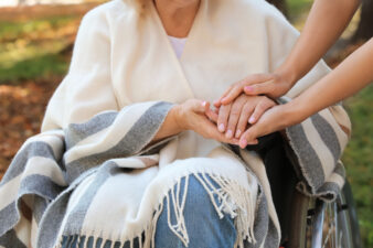 Close up of senior woman in wheelchair with caregiver