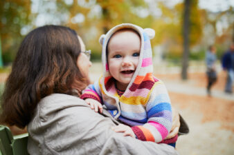 Grandmother and granddaughter together in autumn park