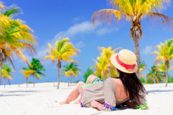 Young girl lying on tropical beach