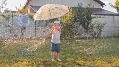 Kid outside with an umbrella