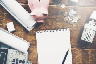 piggy bank, notebook and pen, and calculator for financial planning