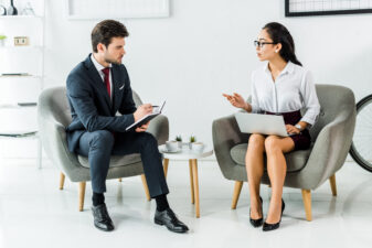 man and woman speaking in a business meeting