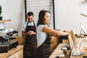 female employee putting items in a brown bag