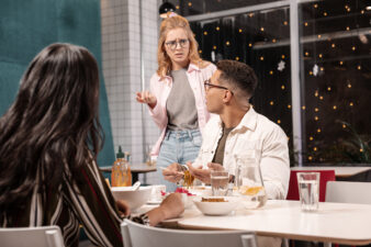 Three people speaking outside