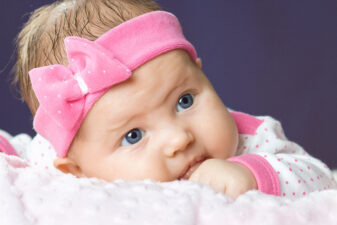 Cute little baby girl with pink bow