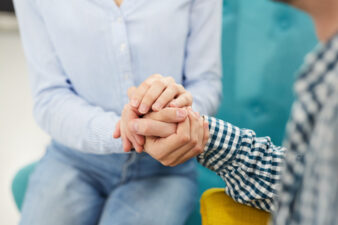 Close up of two people holding hands