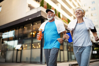 Happy senior people running downtown