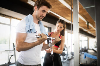 Woman working with a male client as a personal trainer