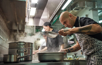 Two males working in a kitchen