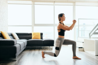 woman doing lunges in the living room