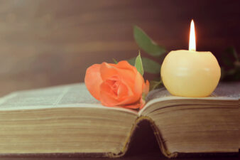 Candle, book and flower