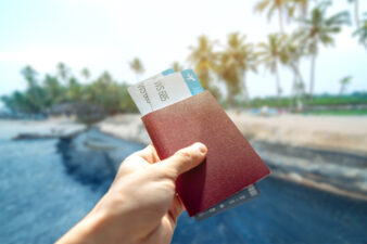 Hand holding a wallet with airline tickets