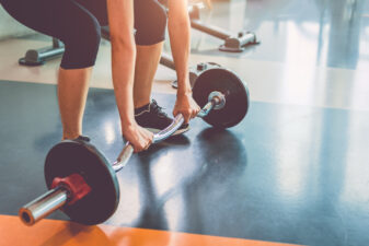 close up of woman lifting a weight