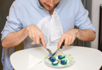 A young man doing the tide pod challenge