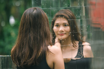 Woman looking at herself in the mirror