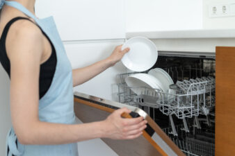 Woman loading the dishwasher