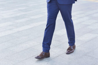 Man walking with blue pants, brown shoes