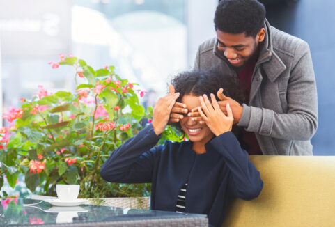 Black man surprising a black woman