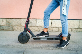 Close up on female legs on a scooter