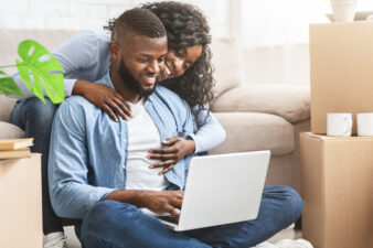 African couple looking at a laptop