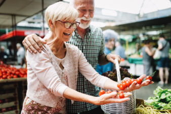 senior couple shopping at a farmer's market