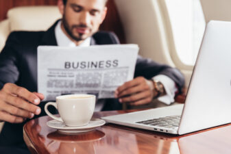 man looking at a business newspaper