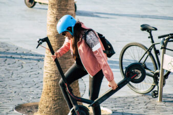 Woman holding her electric scooter