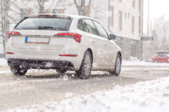 Car driving through snowfall