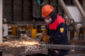 Industrial working cutting metal with sparks flying