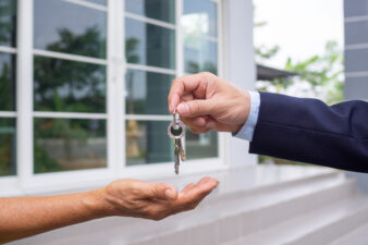 handing over keys to new homebuyer