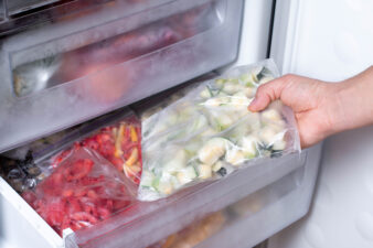 Person taking reusable food storage bags out of freezer